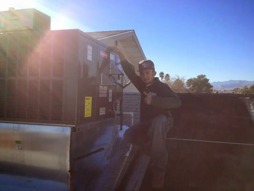 HVAC technician performing HVAC Inspection on a rooftop unit in Bradley